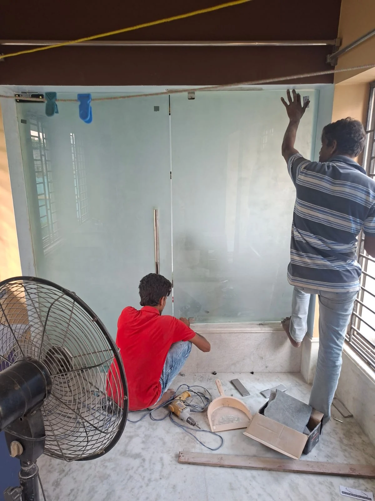 Glass partition installation in progress
